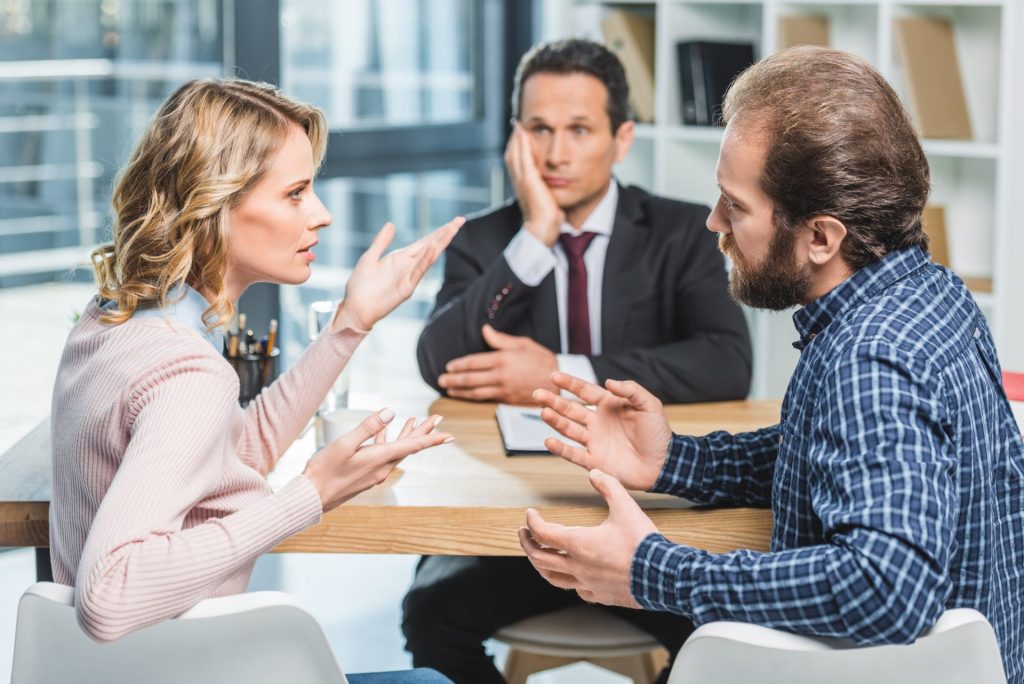 side view of couple arguing at workplace in lawyer office.jpg