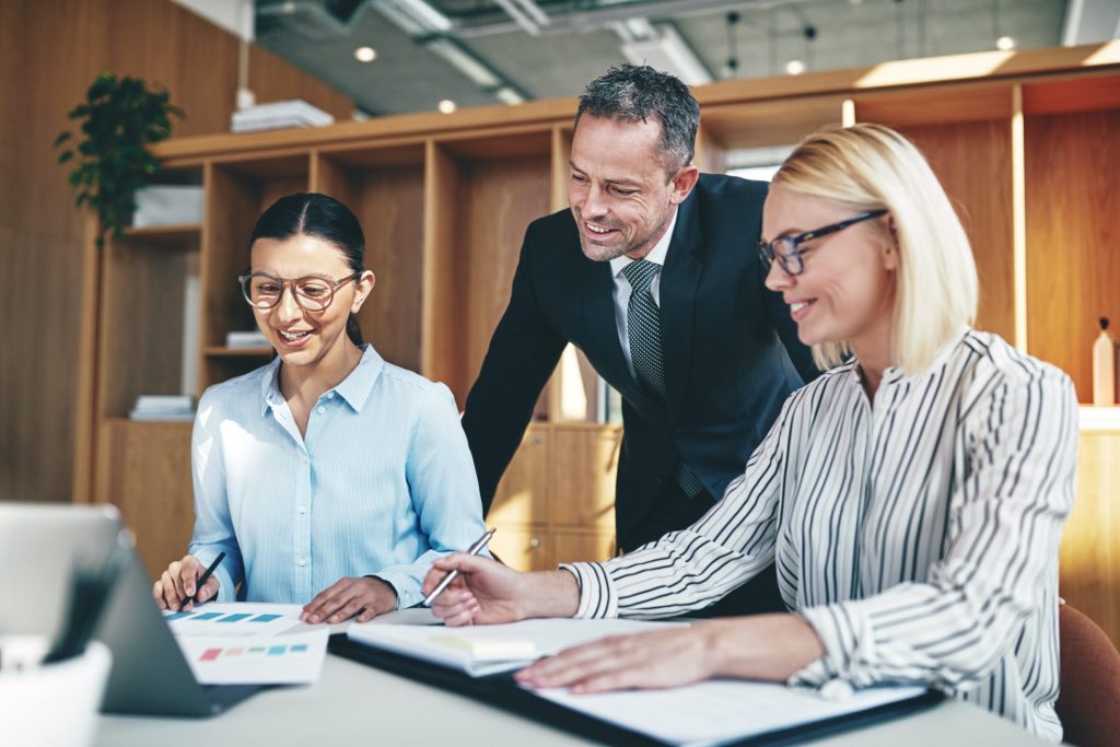 smiling businesspeople working together at an office table.jpg