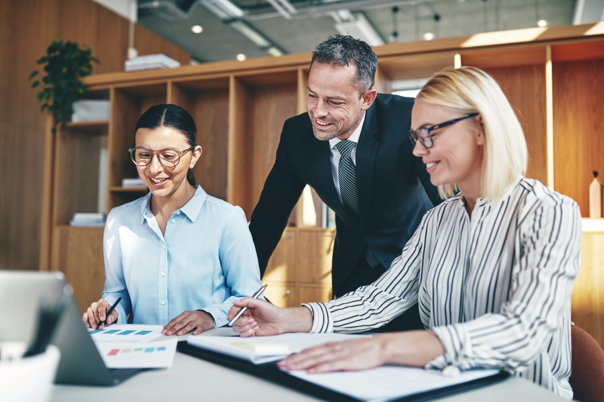smiling businesspeople working together at an office table.jpg