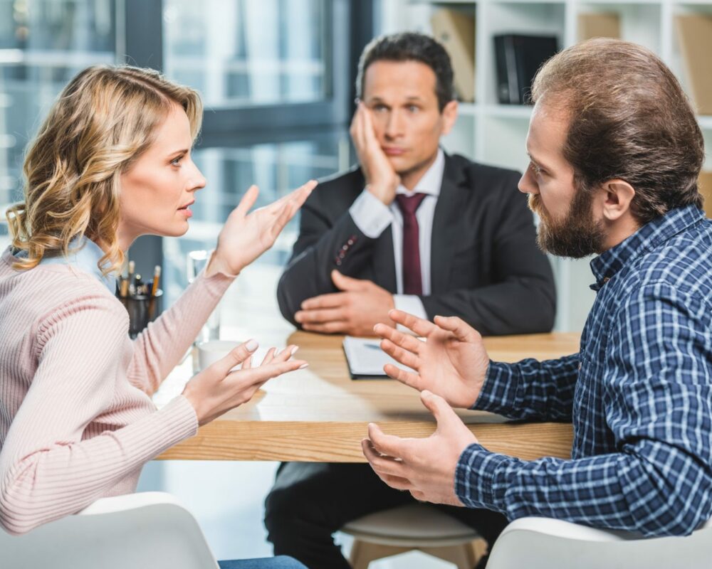 side view of couple arguing at workplace in lawyer office.jpg